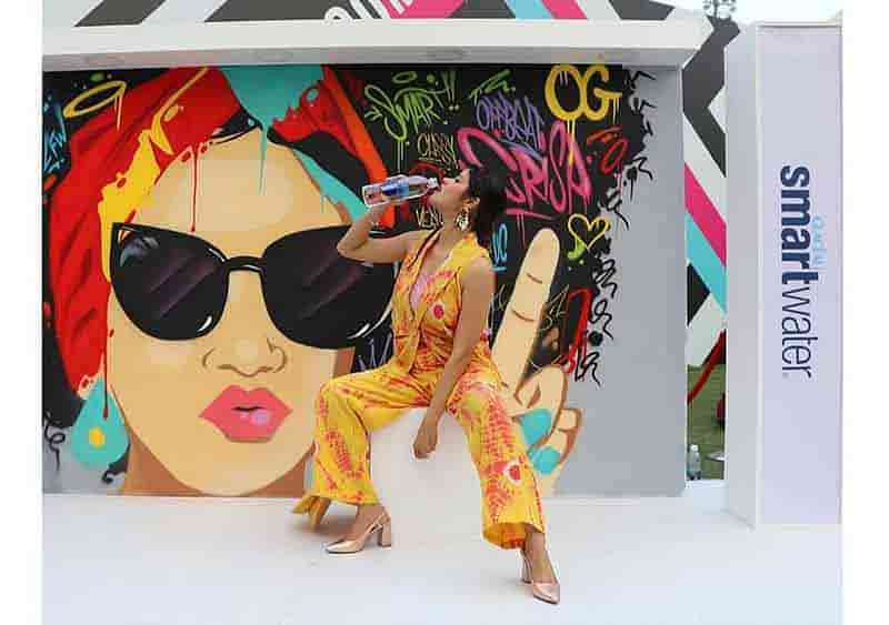 model drinking smart water at lakme fashion event posing at live graffiti designed by wickedbroz artist