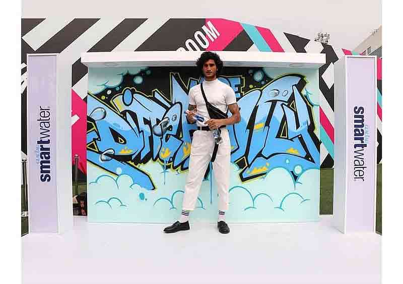 male model posing in front of graffiti by wicked broz at lakme fashion week